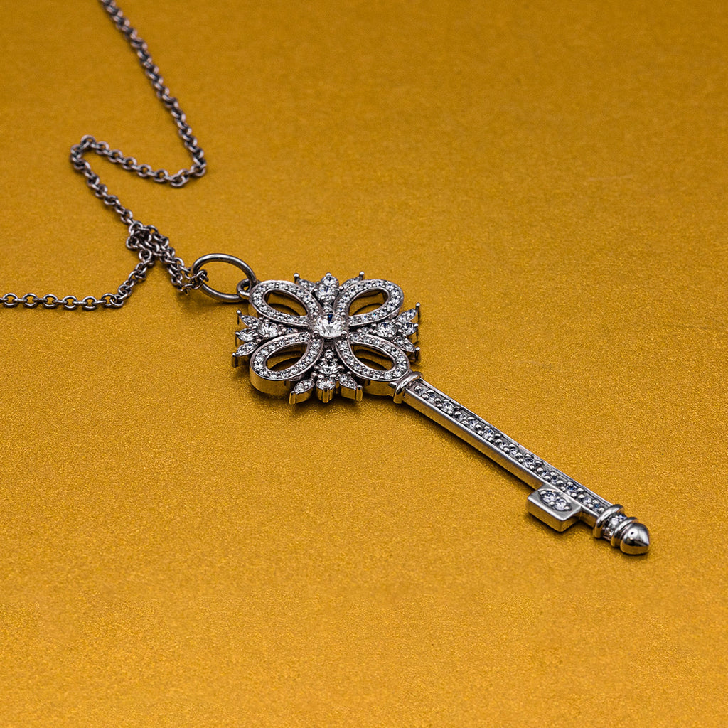 pre-owned 18ct white gold key pendant with diamonds