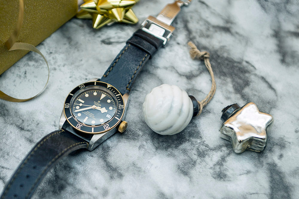Tudor watch with black and gold face